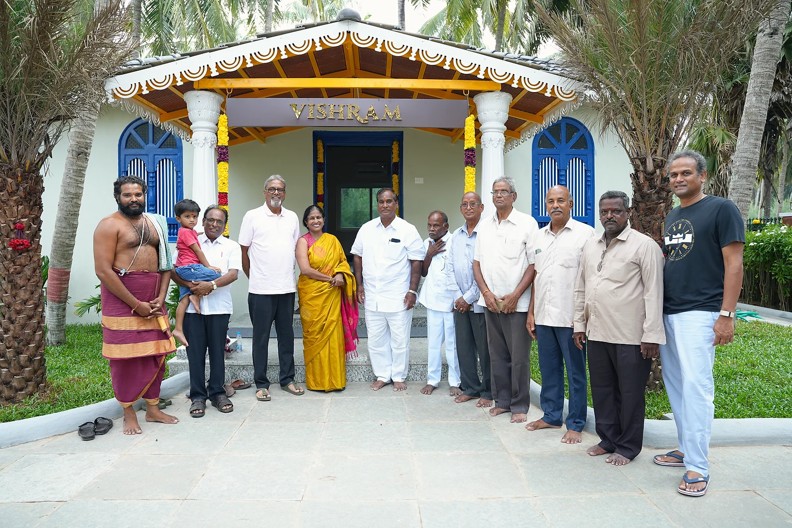 Guests gathering outside the flower-decorated Vishram building during the grand launch