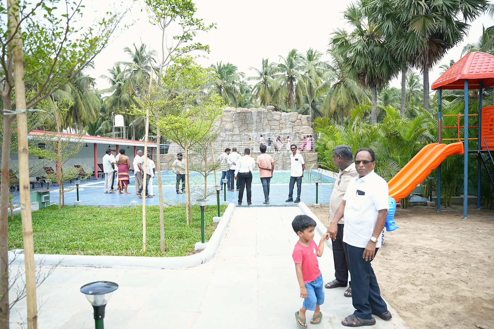 Grand launch guests exploring the garden, pool area and children's playground