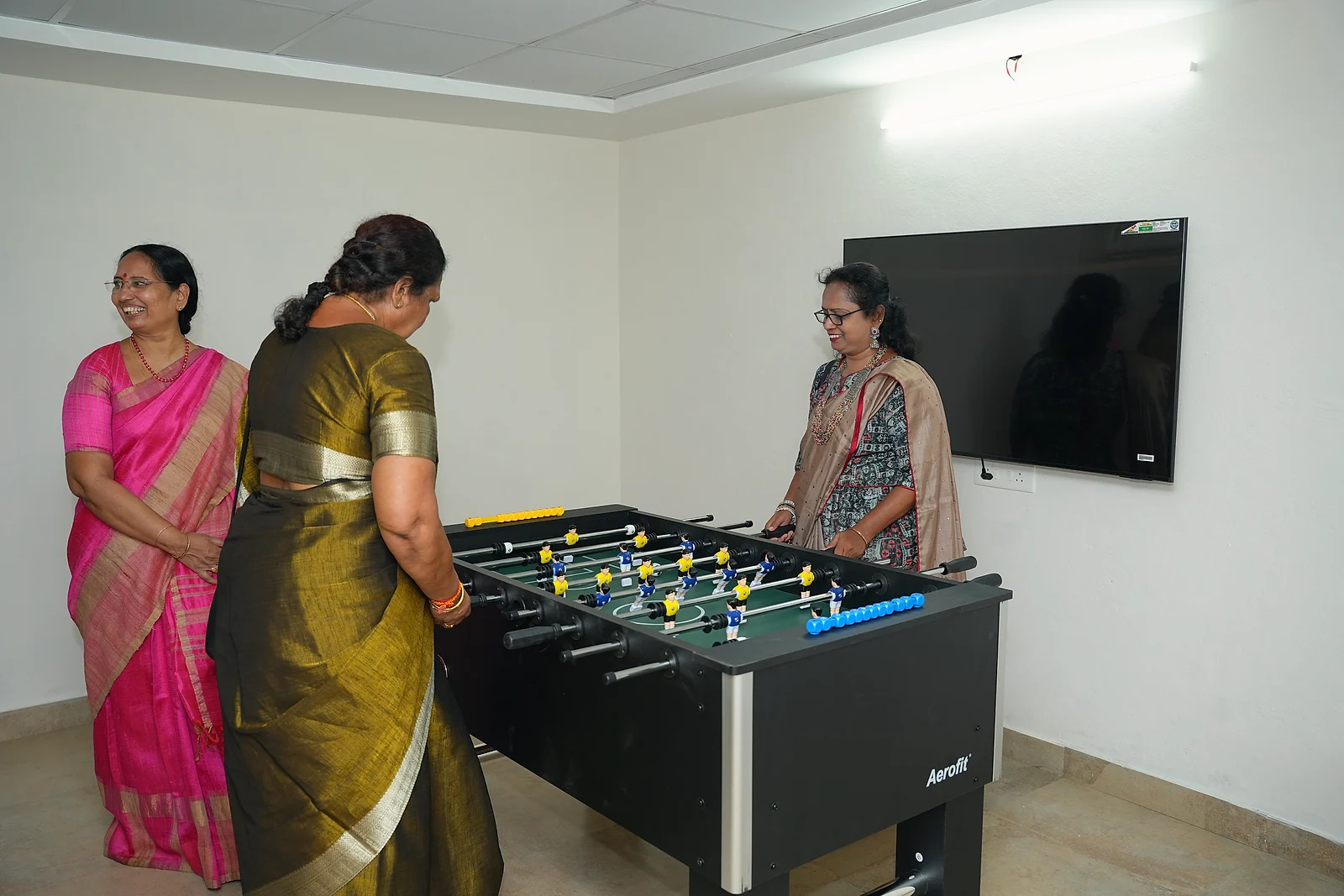 Guests playing table football in the resort recreation room